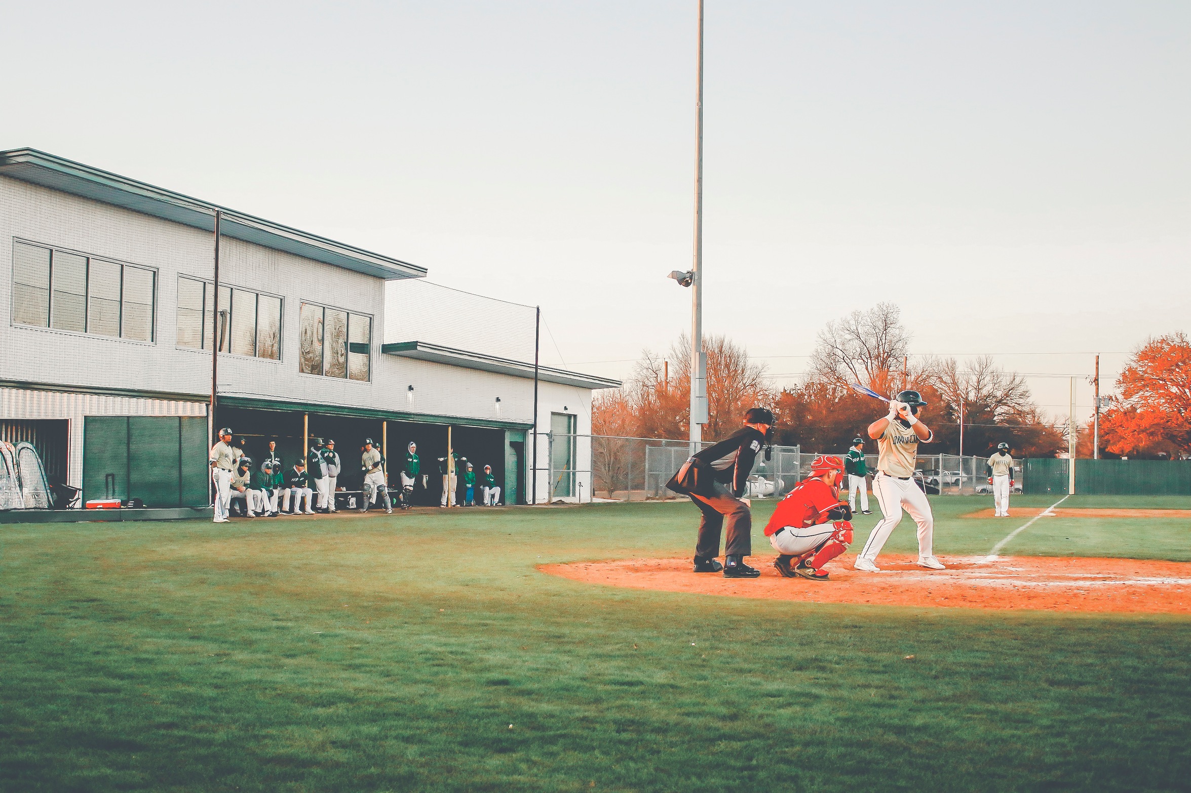 batter at home plate with LJ Powell Baseball Training center in background