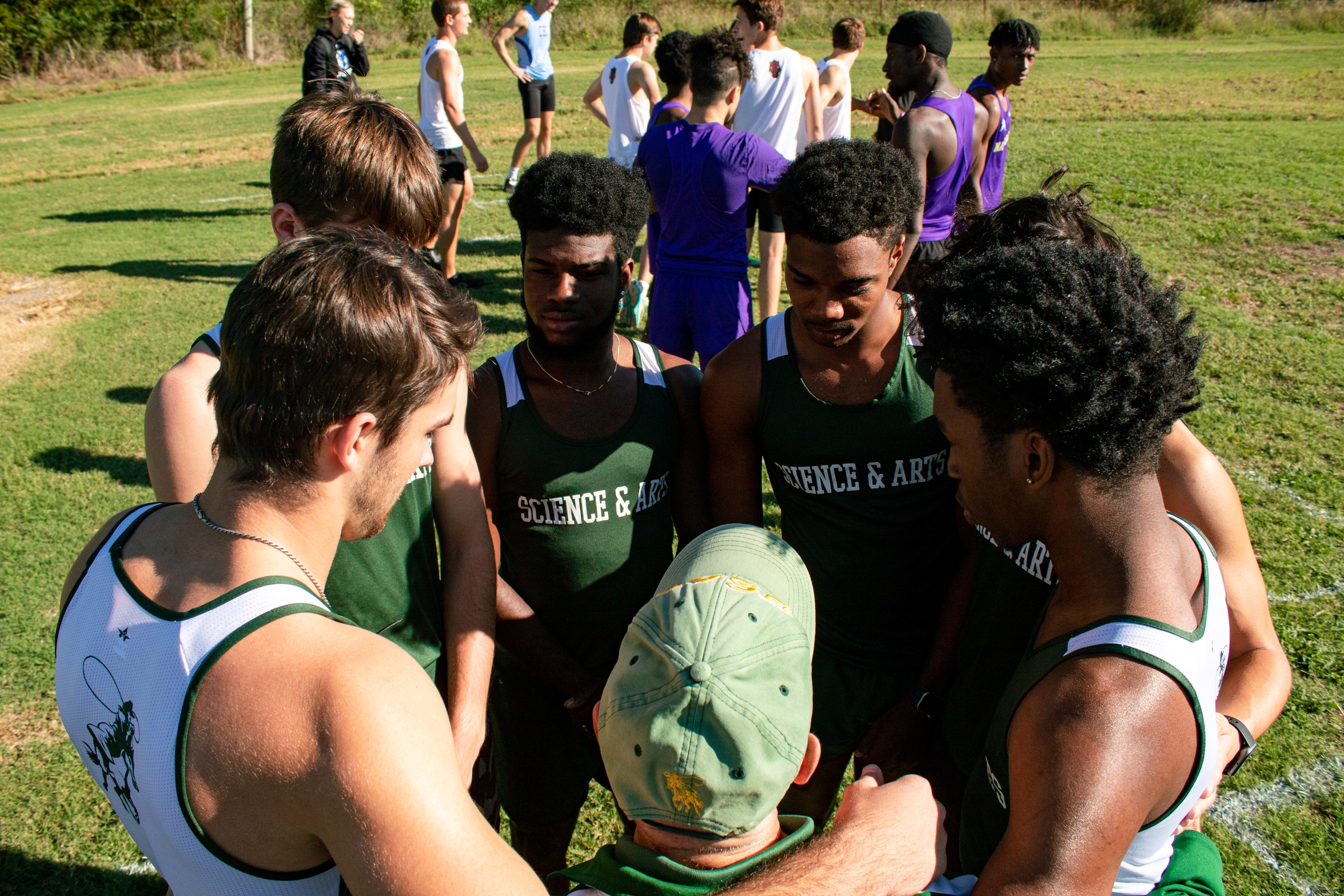 cross country team huddles before a race